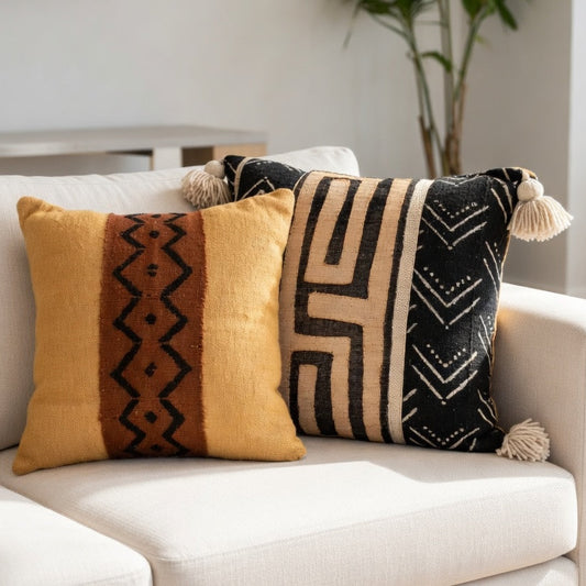 Decorative pillows with tribal patterns on a white sofa in a living room setting.